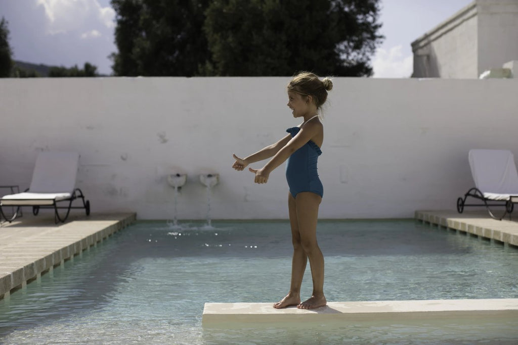 US stockist of Canopea's Bari Green halterneck swimsuit with ruffle at neck and back.  Made from recycled UPF 50 fabric.