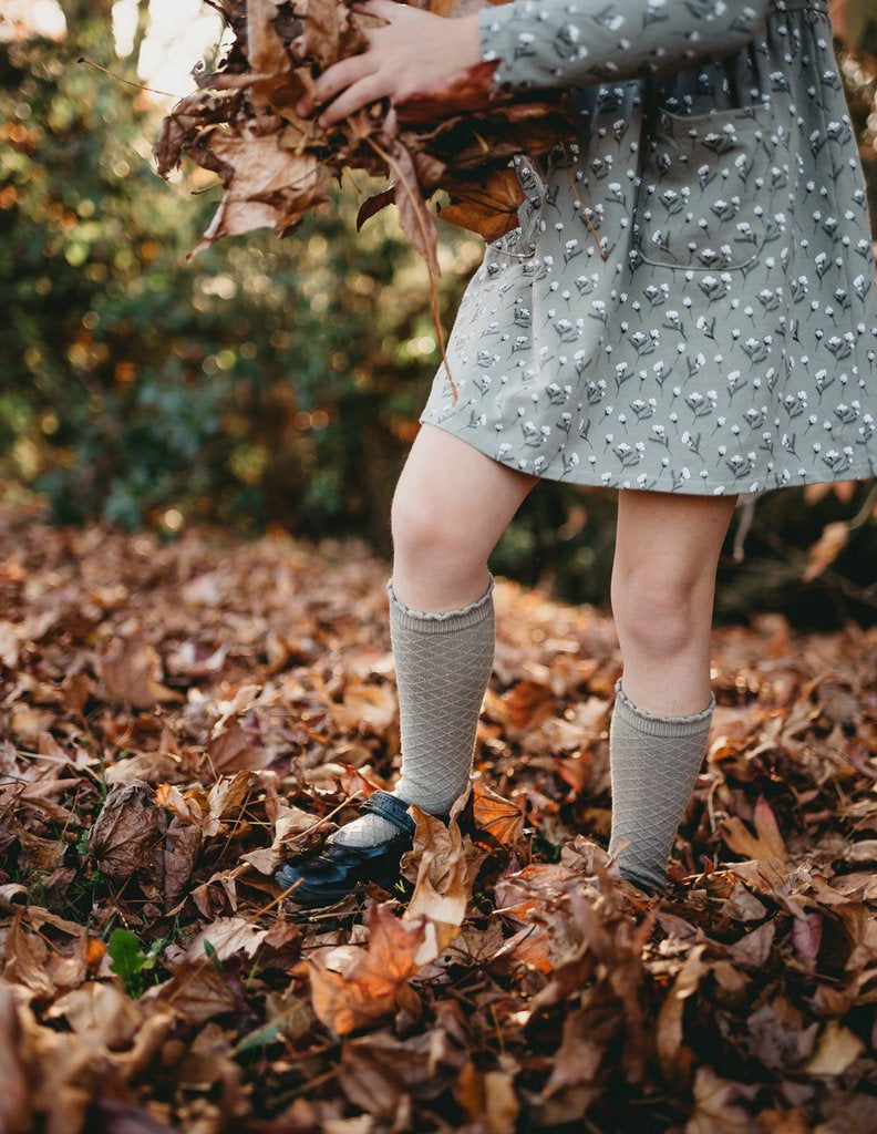 US stockist of Karibou Kid's Conifer cotton socks. Dusty sage green color with mesh texture and frill at top. Cotton blend.