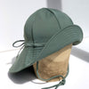 US stockist of Fini the Label's gender neutral, floppy swim hat in Ivy Green. Features elongated back for added sun protection, chin strap and adjustable bow around crown for better fit. Brim is medium stiffness and can be flipped up at front.  Made from nylon/spandex and is quick drying.