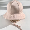 US stockist of Fini the Label's gender neutral, floppy swim hat in Shimmer Champagne. Features elongated back for added sun protection, chin strap and adjustable bow around crown for better fit. Brim is medium stiffness and can be flipped up at front.  Made from nylon/spandex and is quick drying.