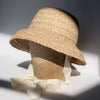 US stockist of Fini the Label's vintage French style straw hat.  Made from raffia straw with a wide bell shaped brim and a trimmed natural ribbon beget chin strap.