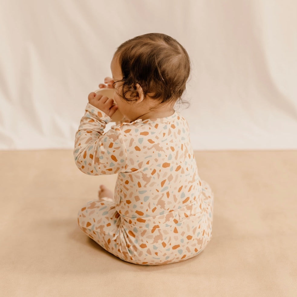 US stockist of India & Grace's long sleeve, gender neutral organic bodysuit in Dino Terrazzo.