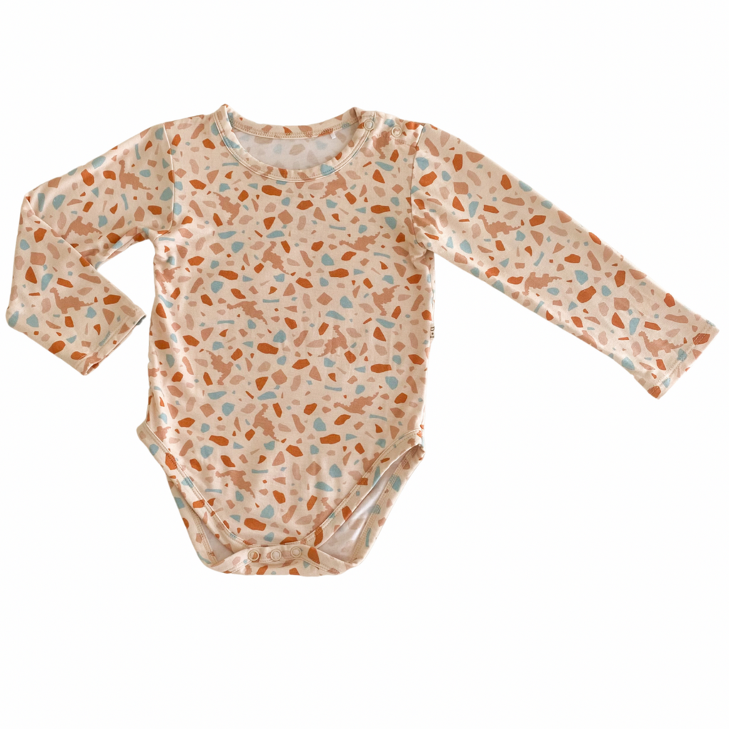 US stockist of India & Grace's long sleeve, gender neutral organic bodysuit in Dino Terrazzo.