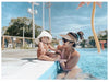 US stockist of Fini the Label's gender neutral, floppy swim hat in cream. Features elongated back for added sun protection, chin strap and adjustable bow around crown for better fit. Brim is medium stiffness and can be flipped up at front.  Made from nylon/spandex and is quick drying.