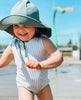 US stockist of Fini the Label's gender neutral, floppy swim hat in Ivy Green. Features elongated back for added sun protection, chin strap and adjustable bow around crown for better fit. Brim is medium stiffness and can be flipped up at front.  Made from nylon/spandex and is quick drying.