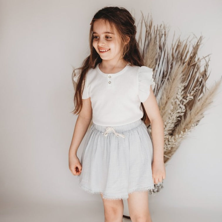 US stockist of Karibou Kids Keira Flutter Sleeve Waffle top in whipped cream.  Made from a soft cotton and spandex blend.