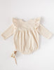 US stockist of Karibou Kid's Milana Winged Playsuit in almond cream.  Made from soft cotton, featuring long sleeves and ruffled wings at shoulders.