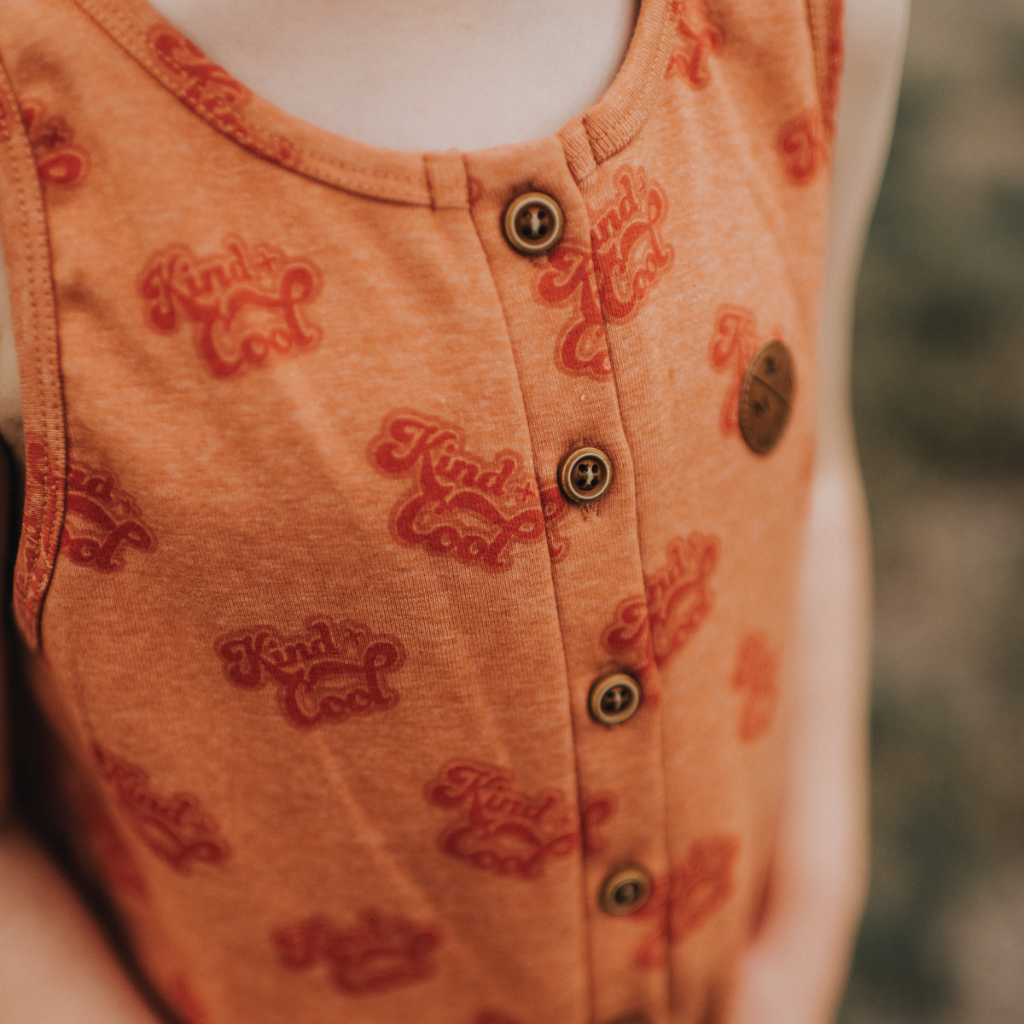 US stockist of My Brother John's Ziggy Stomper. Tank romper in a warm orange color with cozy fleece lining and rolled leg cuffs.  Great worn layered.