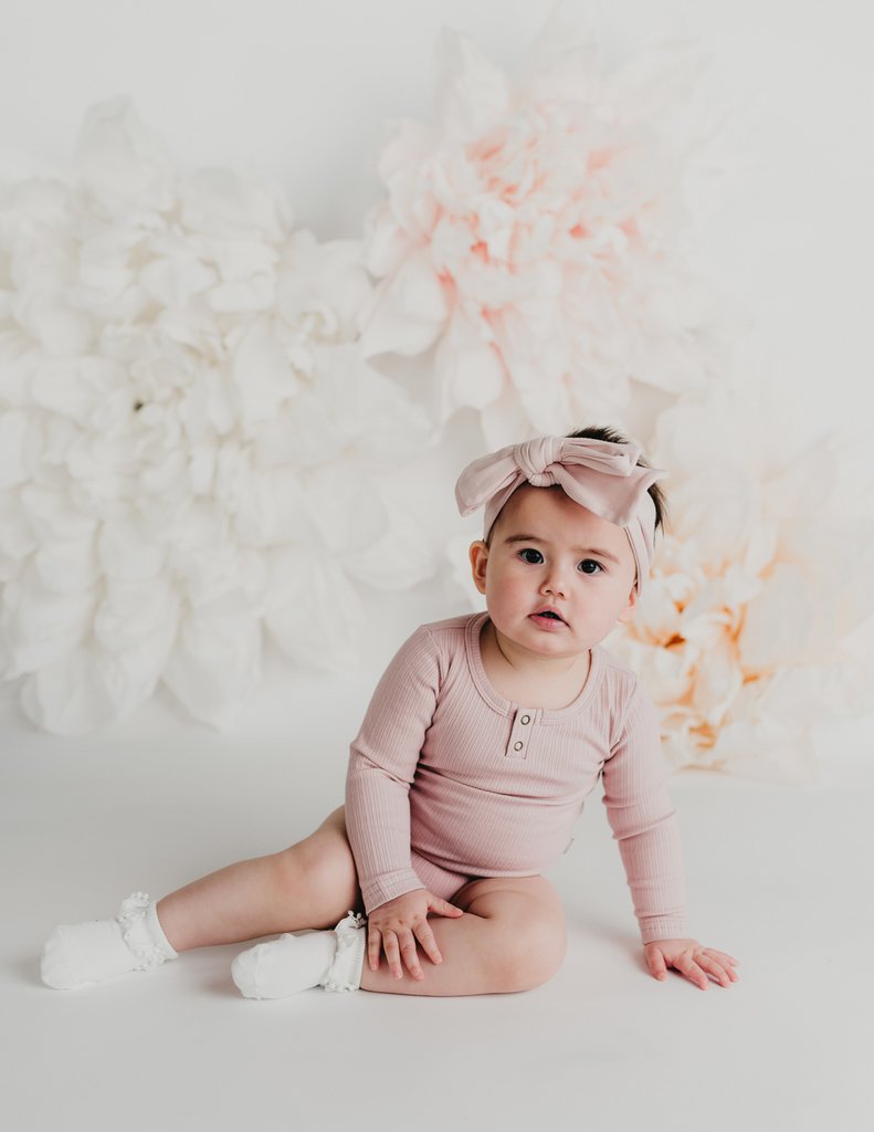 US stockist of Karibou Kid's white ankle pom pom ruffle socks.  Made from a cotton blend.