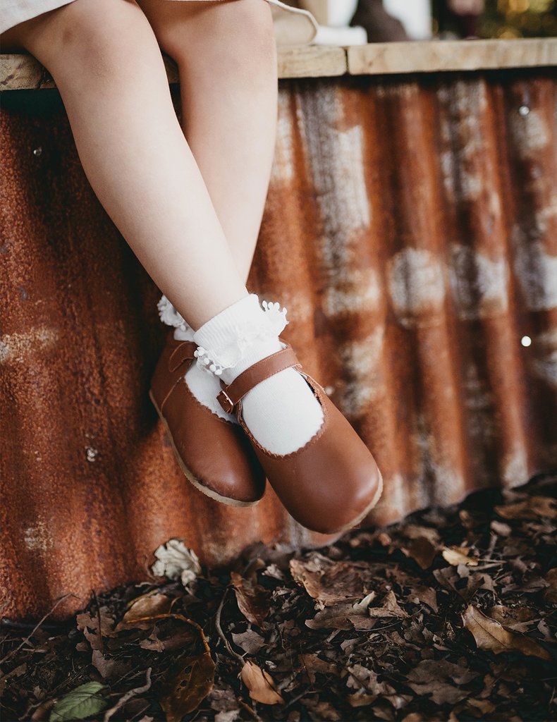 US stockist of Karibou Kid's white ankle pom pom ruffle socks.  Made from a cotton blend.
