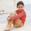 US stockist of Canopea's gender neutral, Grenada Red long sleeve rash top made from recycled UPF 50+ fabric.