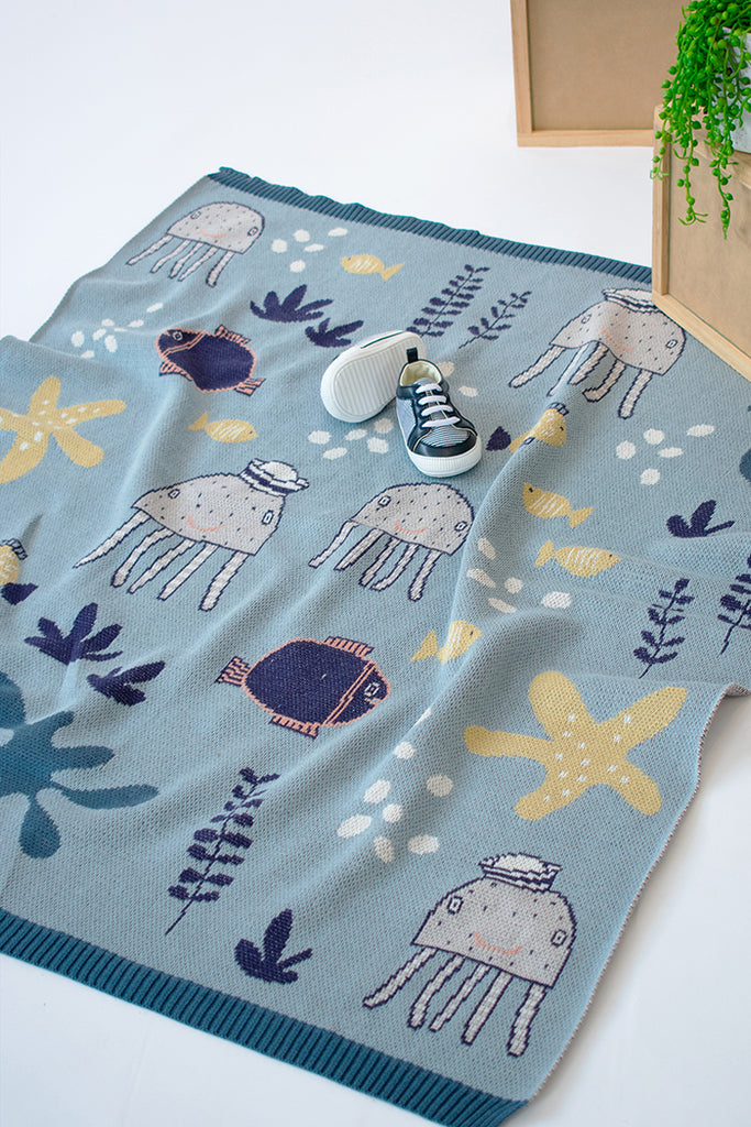 US stockist of Indus Design's "Under the Sea" blue cotton baby blanket.  Features a print with fish, starfish and octopus.  