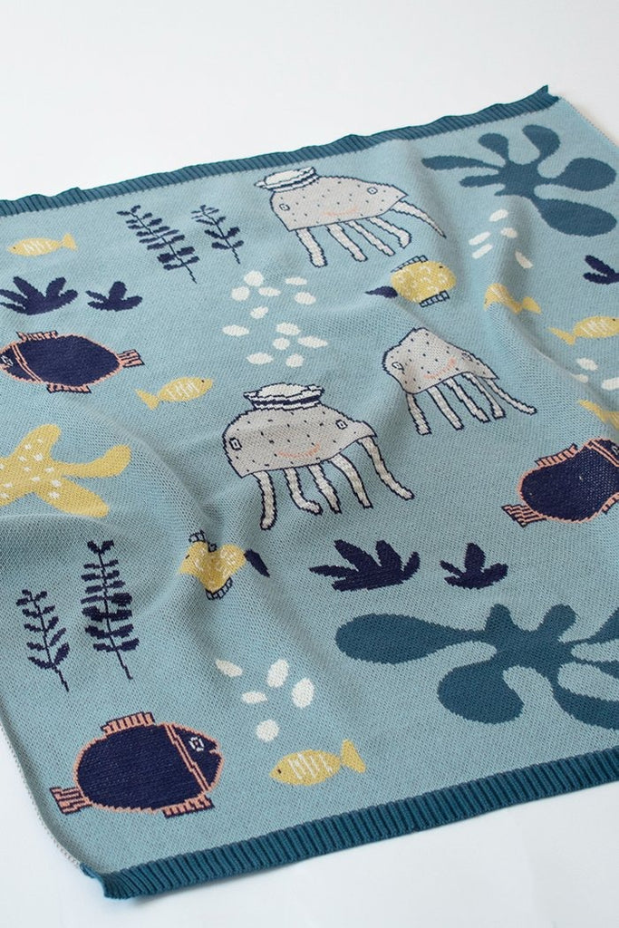 US stockist of Indus Design's "Under the Sea" blue cotton baby blanket.  Features a print with fish, starfish and octopus.  