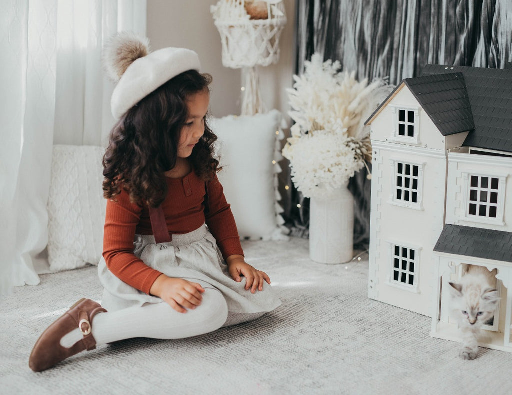 US stockist of Karibou Kid's Coco Linen Suspender Skirt in the Frosted Cherry Edition.  Features natural linen skirt with contrasting mauve suspender straps and bows on back.