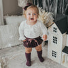 US stockist of Karibou Kids' whimsy love ruffle sleeve, cotton waffle top in snow white.  Features keyhole tie front of neck.